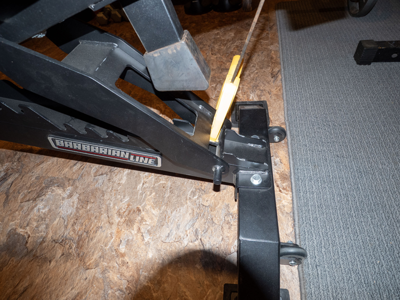Picture of heavy duty weight bench trigger clamped for vertical bench storage. Picture three.